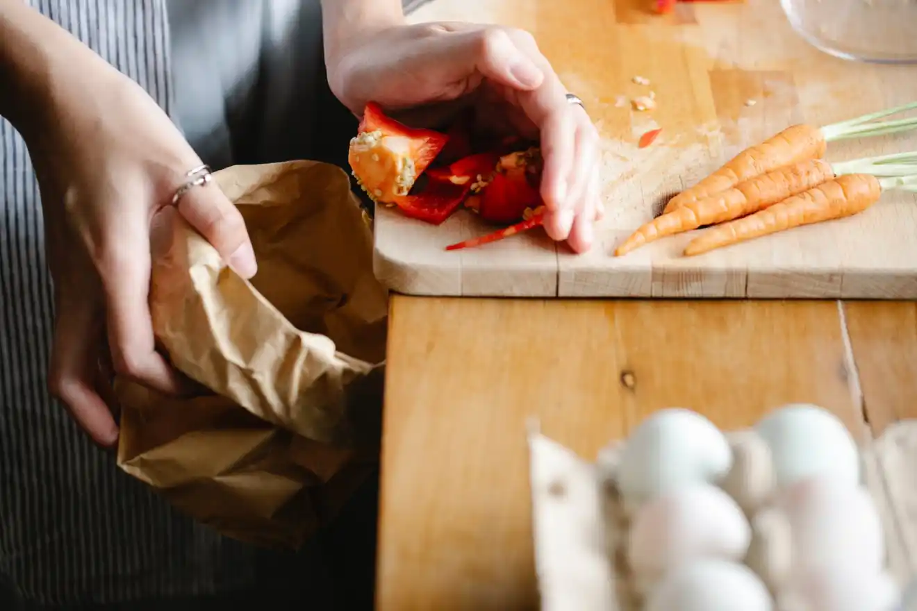 Stop Food Waste - crop woman cleaning cutting board in kitchen