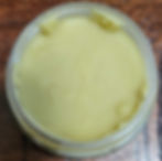 Close up of an open container of Champstick Lip Balm
