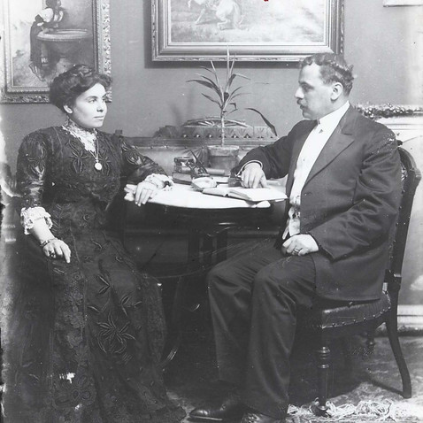Portrait of painter Assad Ghosn and his wife Sadie Gorayib seated at a table