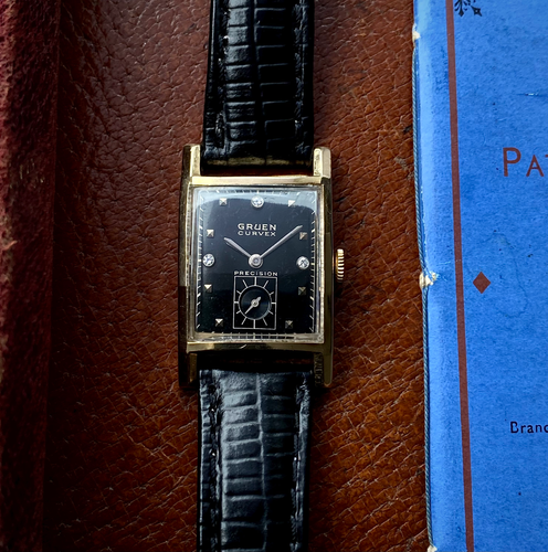 1940s Gruen Curvex Precision 14k gold cased watch with black