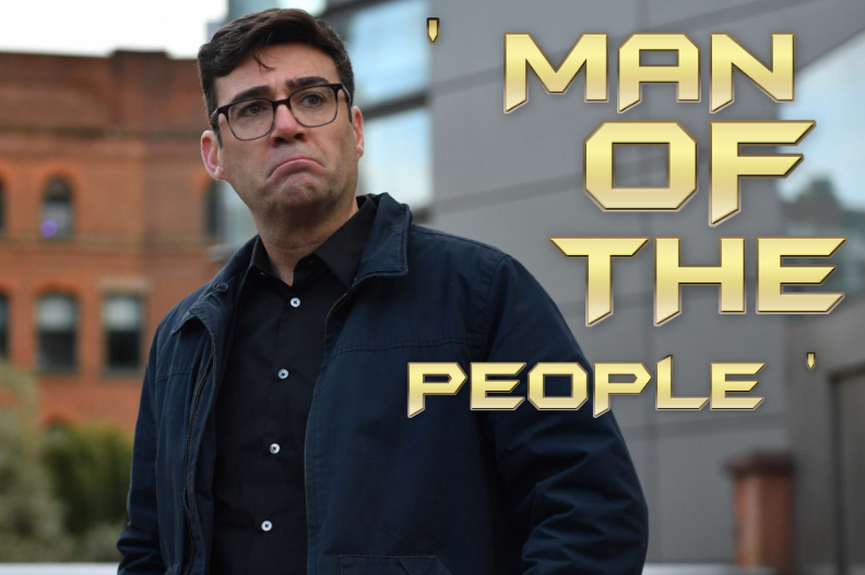Man in glasses and navy jacket stands outdoors in a city, looking concerned beside gold title text MAN OF THE PEOPLE.