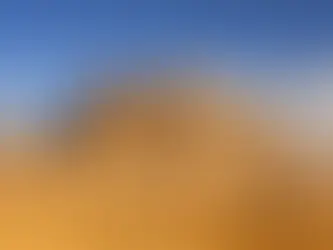 Eye-level view of the Great Pyramid of Giza under a clear blue sky