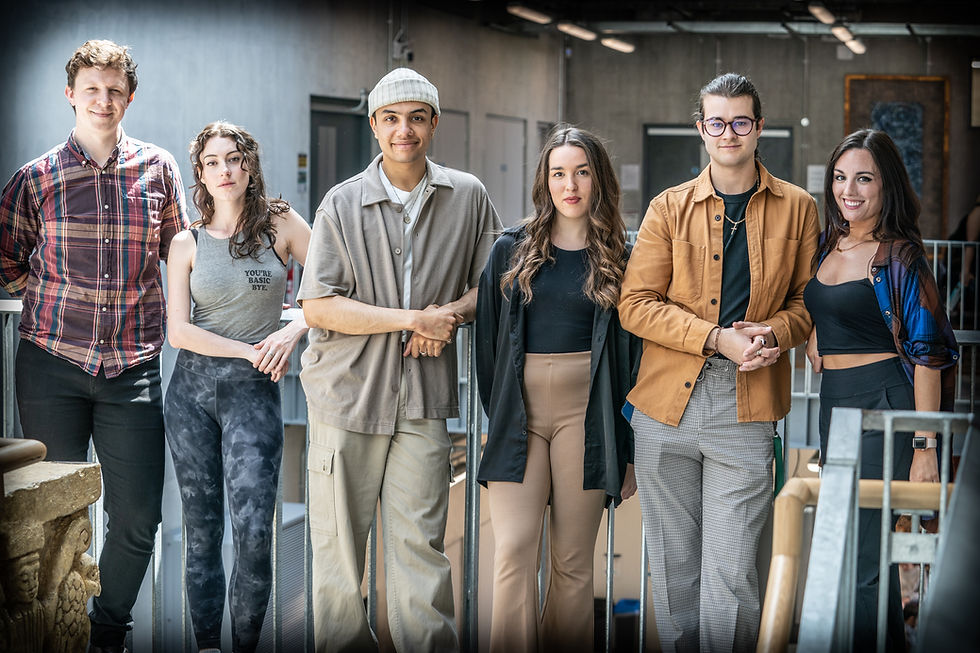 The cast pose in a line