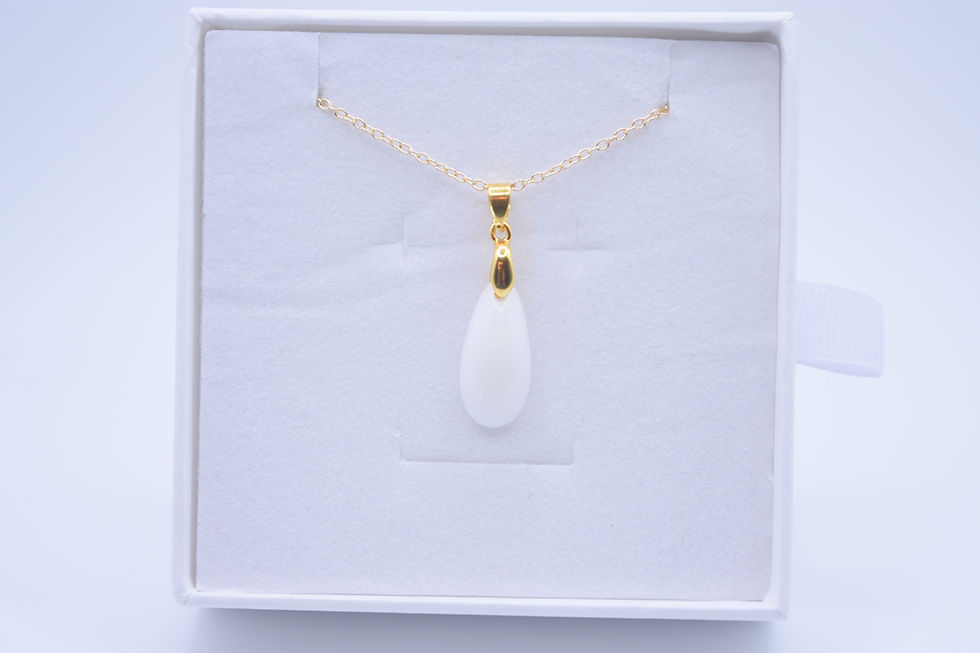 Eye-level view of a beautiful breastmilk pendant on a simple necklace chain