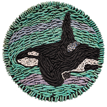 woven art using reclaimed fishing rope creating an image of a male killer whale swiming in the ocean