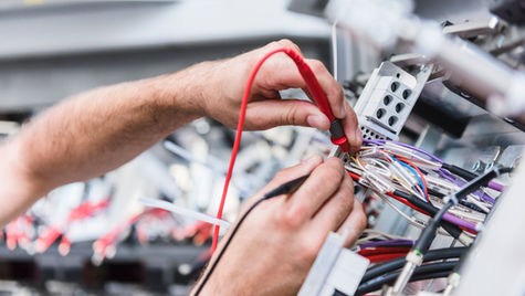 Hands and a wire testing kit