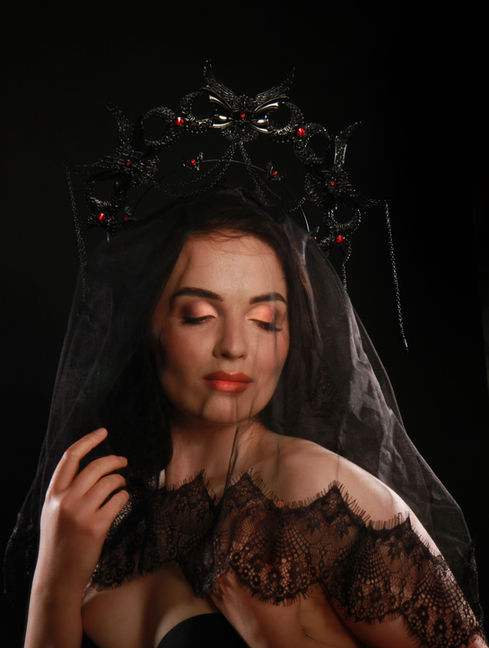 Boudoir image of female in lingerie with black headpiece and veil