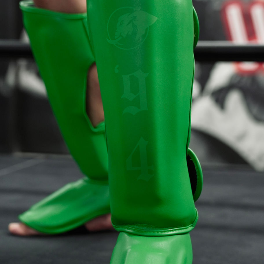 Green Muay Thai kickboxing shin guards for comfort and performance