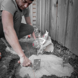 Man spreading concrete into foundation