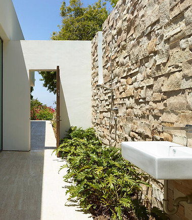 Rustic natural stone, crisp white walls and travertine floor.