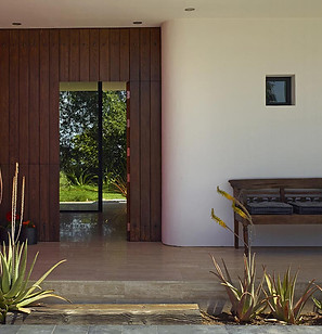 Custom made dutch door, white stucco walls, antique bench. 