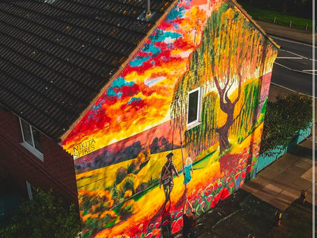 A building blighted by years of vandalism has been transformed with a remembrance-themed mural.