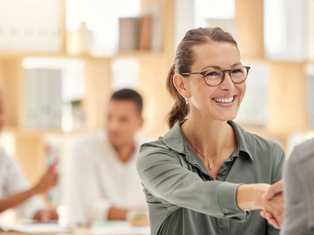 Woman with glasses shaking hands