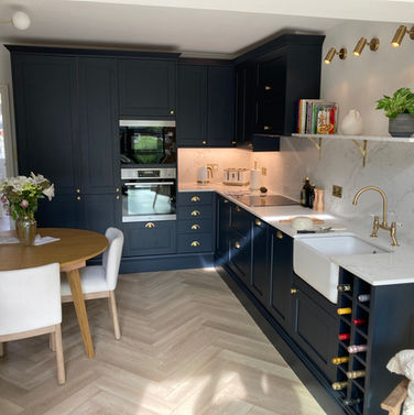 Dark blue kitchen with brass fixtures and fittings