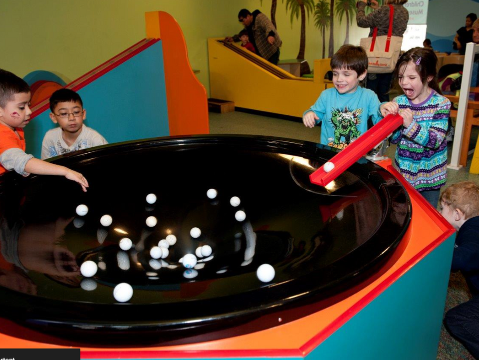 falling balls into circle black table on display at the museum in oak lawn