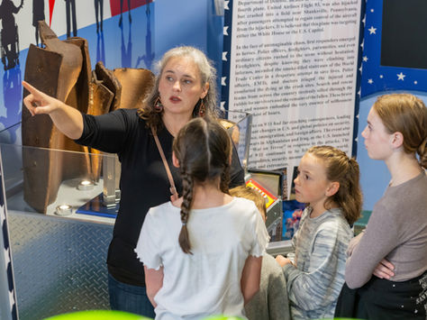 teacher showing the museums special exhibit
