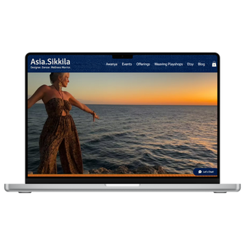 Laptop displaying Asia Sikkila website with woman at sunset