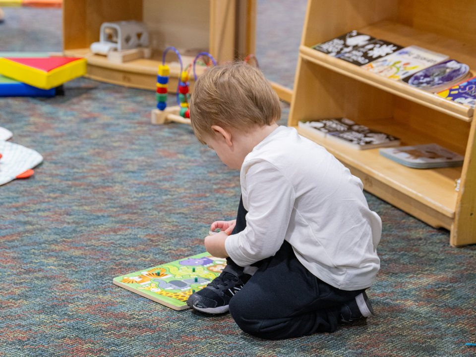 little boy playing with toys at the museum of oak lawn