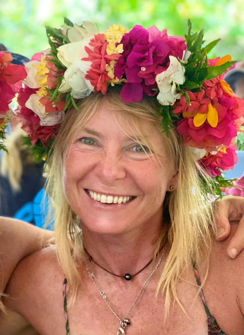 Susan wearing flowers with a warm smile
