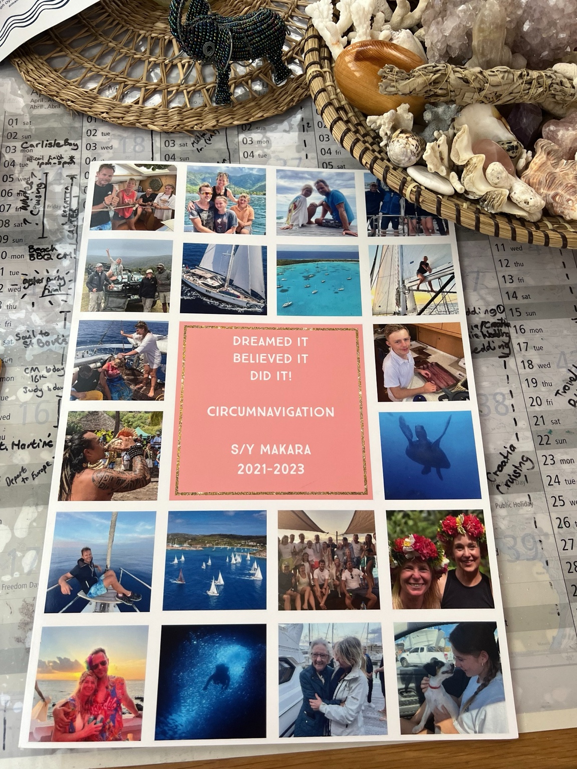 Gift card celebrating our Makara circumnavigation, photographed on the yacht’s chart table alongside the voyage calendar, coral and shells gathered during our journey