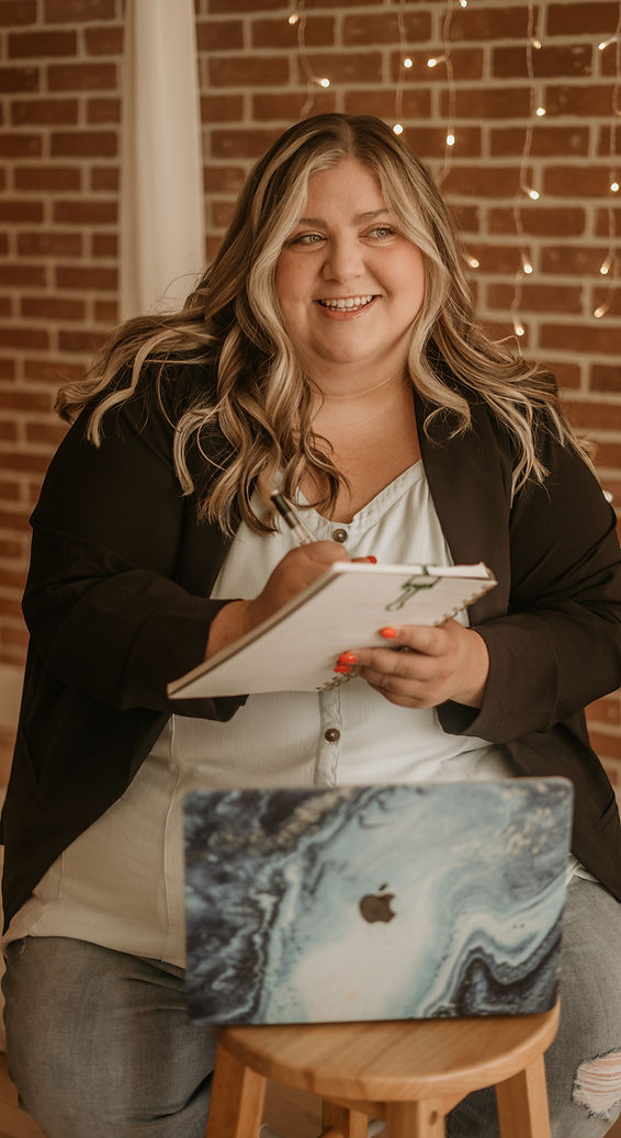 Ashley M. Quinn, Ashley Quinn Long Island Realtor an advocate ready to help people with a notebook and pen in her hand