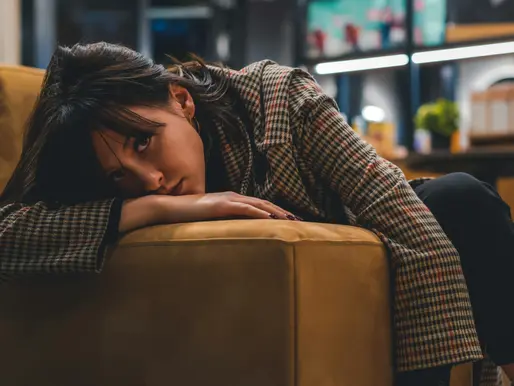 Frustrated woman lay face on couch