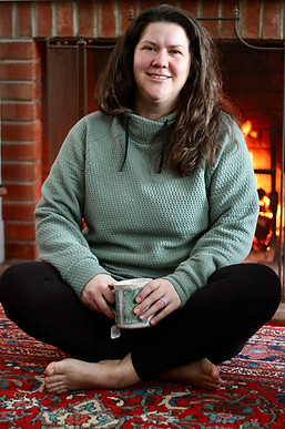 Christy Catsos relaxing by the fire.