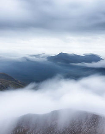 Serene mountain landscape with low-lying clouds and mist, symbolizing clarity, purpose, and elevation—visual representation f