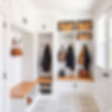 _A bright, modern mudroom with custom-built cabinetry and storage. White shaker-style buil