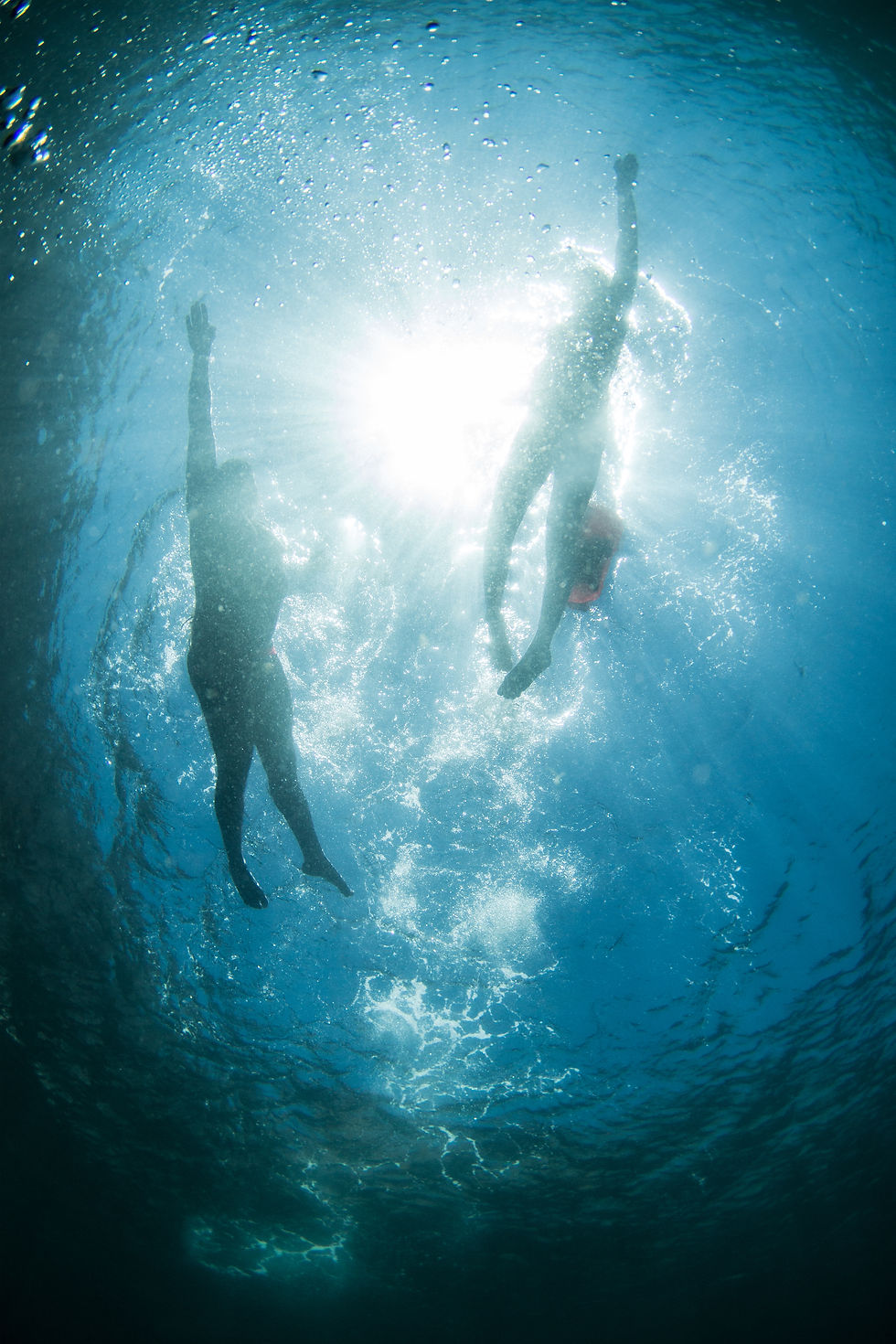 Two swimmers swimming together in the sea in Arrabida Natural Park