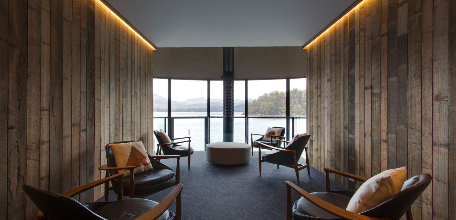 Interior lounge of Pumphouse Point featuring sustainable design by Tasmanian architects, with panoramic views of Lake St Clair