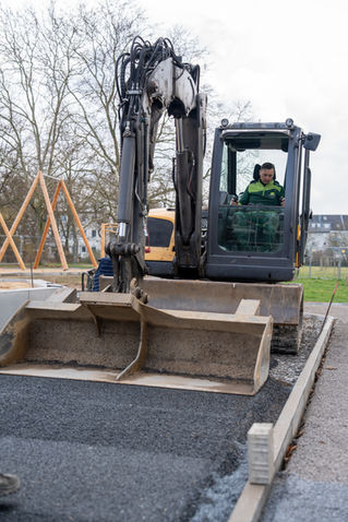 Bagger bei Pflasterarbeiten auf einer Baustelle