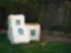 Three white bags with mulch on grass