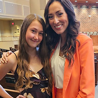 Voice student and voice teacher smiling after successful recital performance