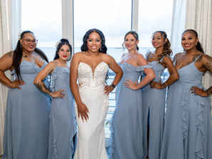 Bride posing with bridesmaids in blue dresses