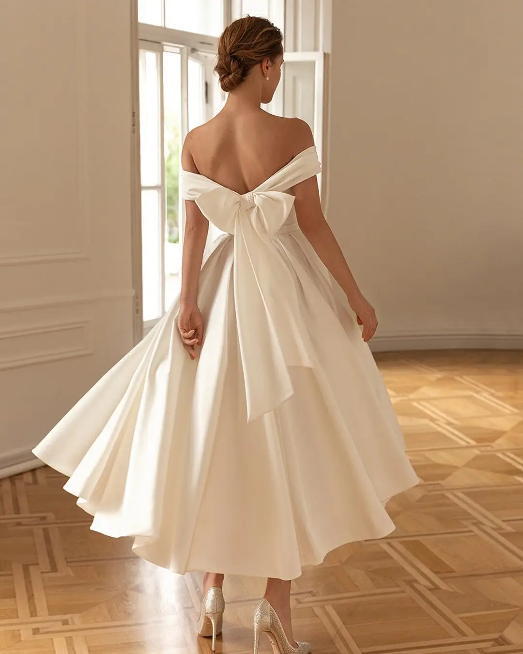 woman wearing tea-line bridal gown