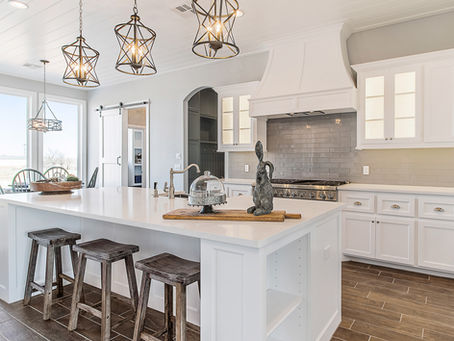 White kitchen with island and oversized hood