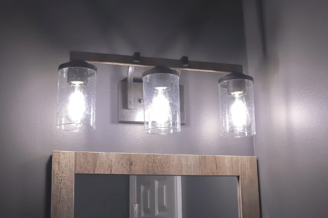 Vanity lights installed above a mirror in a bathroom