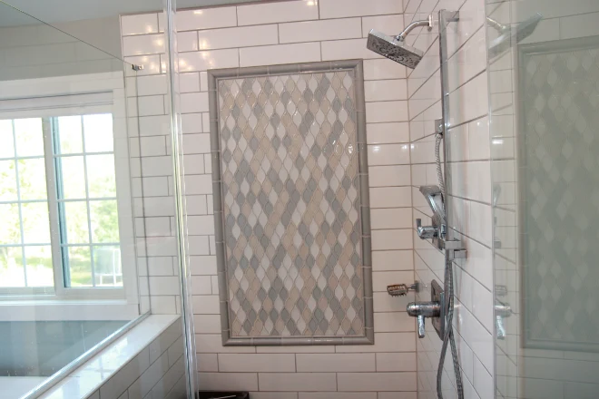 A shower surround featuring complex tile work
