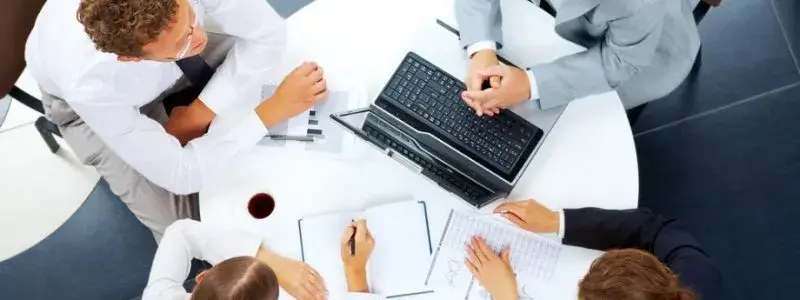 Design team reviewing website navigation on laptop – custom menu design for intuitive, responsive, ADA-compliant UX.