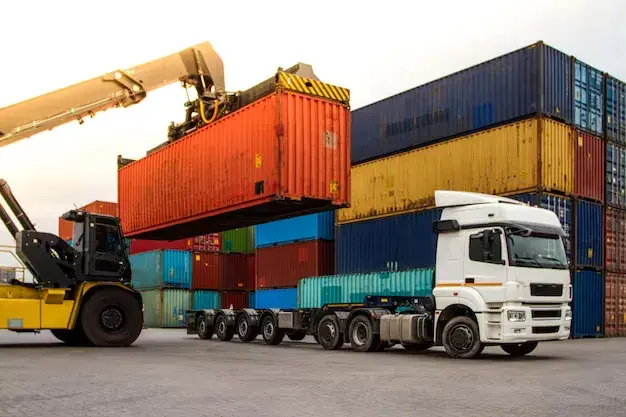 White freight truck being loaded with red shipping container in Bel Air California by Tiger Freight

