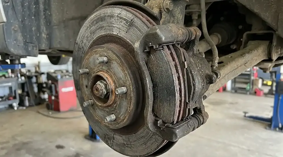 worn brake pads and rotor inspected during best brake repair near me service