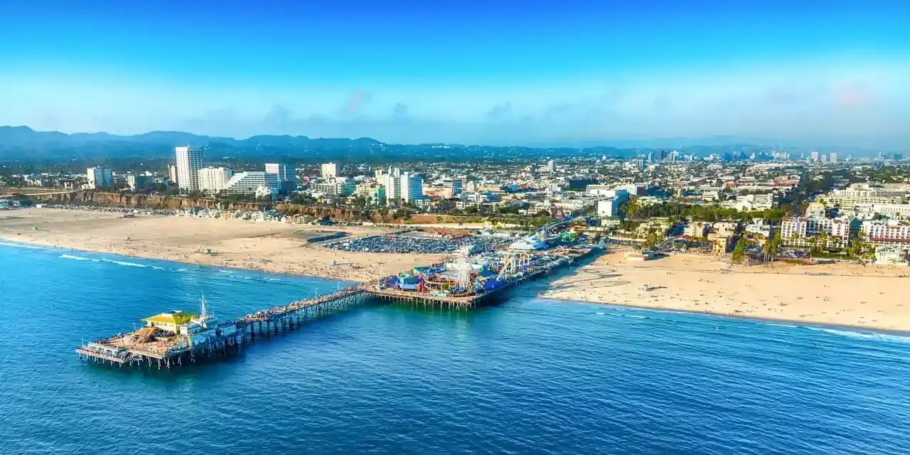Aerial view of Manhattan Beach pier and coastline in California with Tiger Freight services