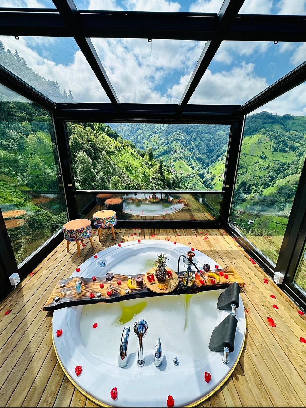 Thumbnail: Bathtub in glass room with mountain valley view