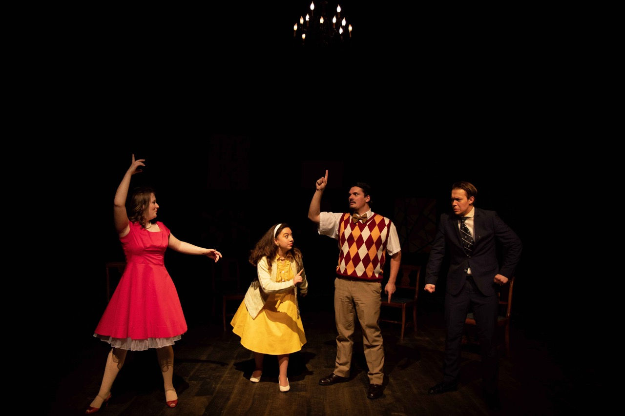 Full-stage view of the absurd domestic setting in performance.