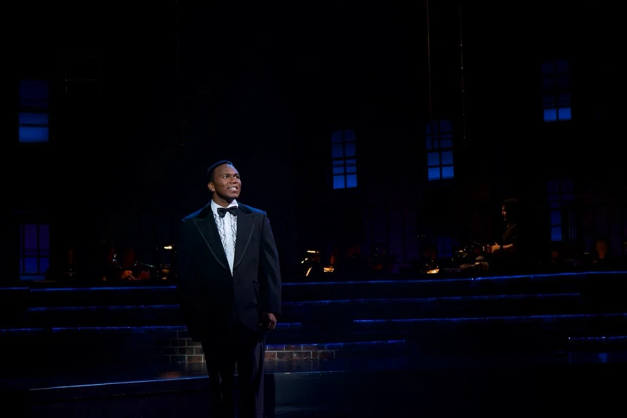Backlit windows and skyline color shaping the mood.