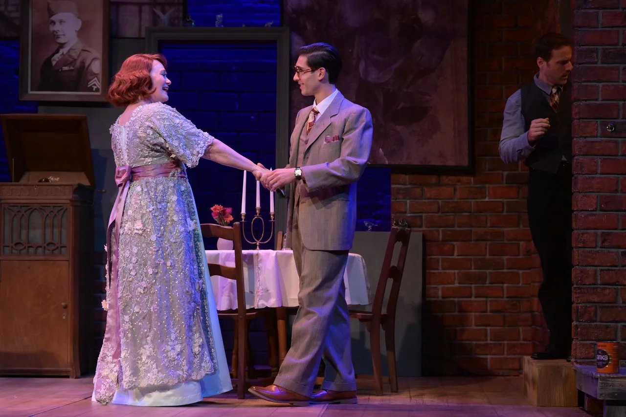 Full-stage view showing layered depth, the Wingfield apartment platform, and the surrounding cityscape in The Glass Menagerie.