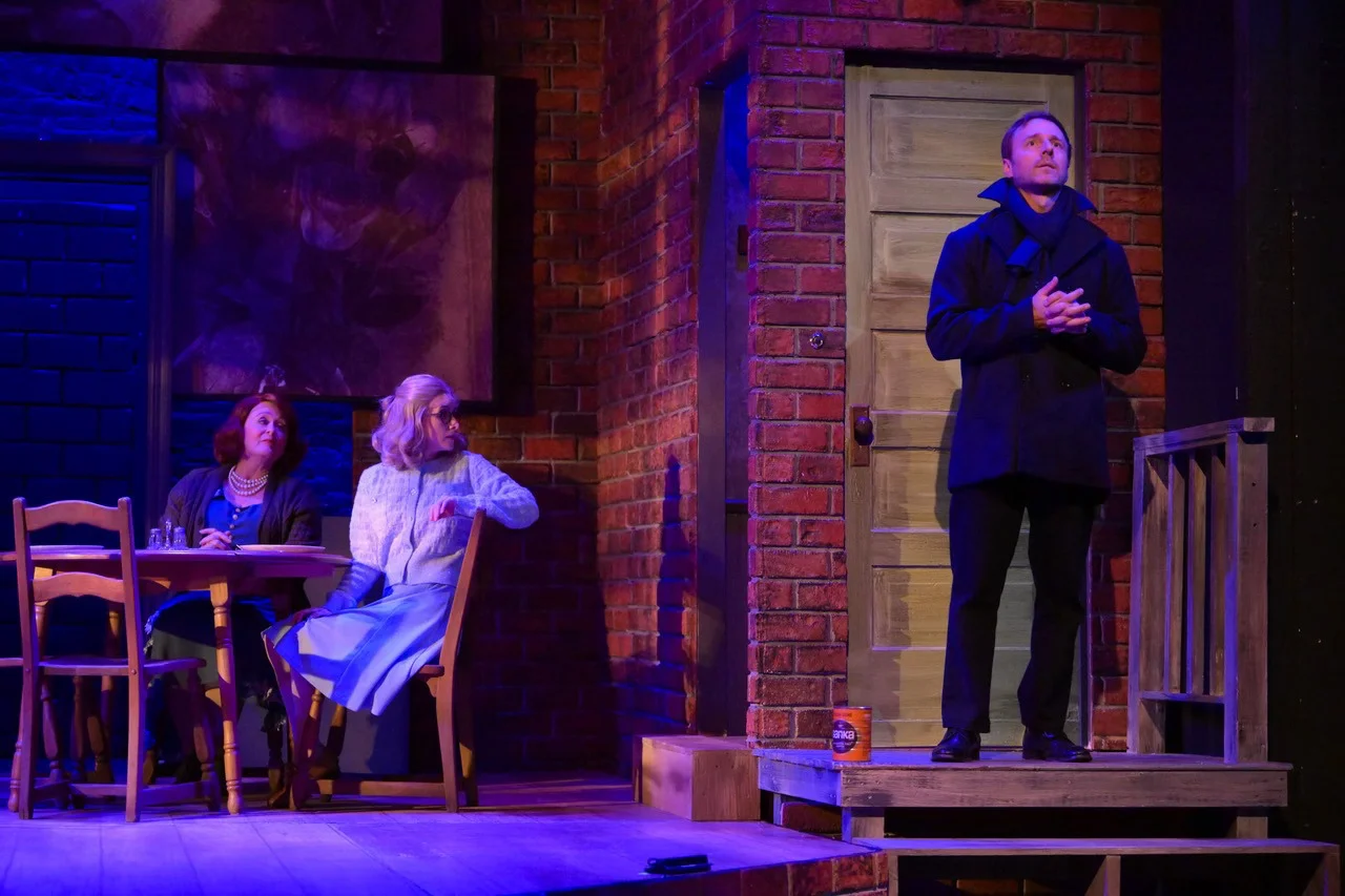 View of The Glass Menagerie with layered scenic planes, exposed thresholds, and negative space around the Wingfield apartment.