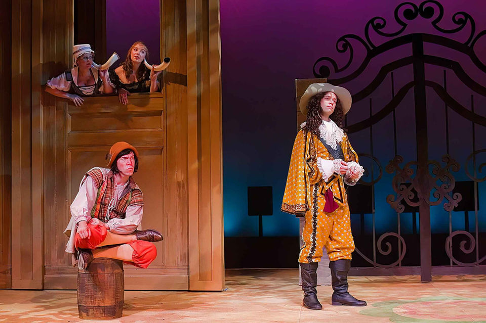 The playful period world and comic staging.