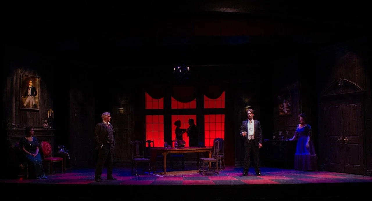 Actors framed by the controlled geometry of the set.